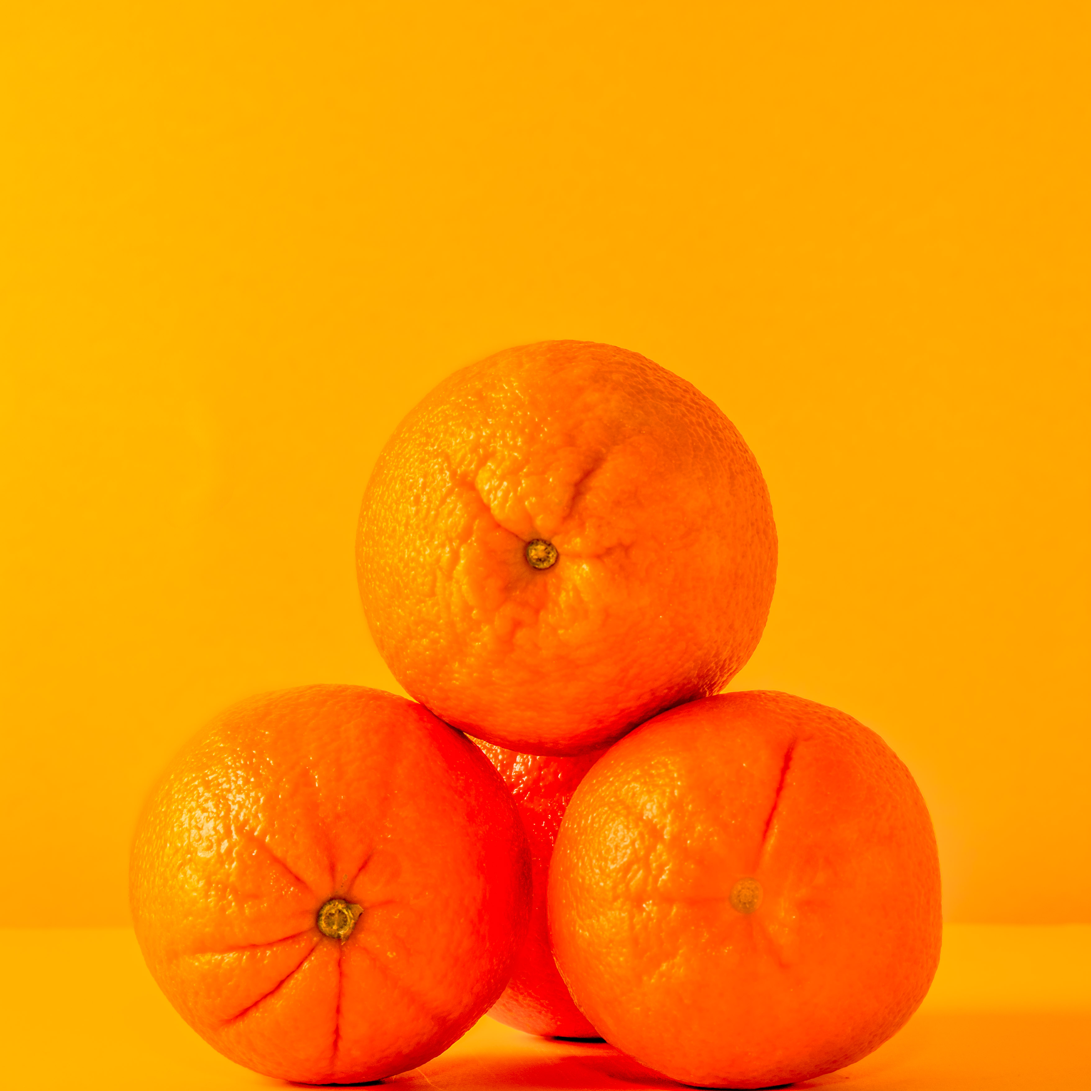 Fresh fruit on non-white background - shot in studio oranges on yellow background shot in studio